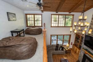 a living room with two beds and a couch at Summit Retreat Seven Springs in Champion