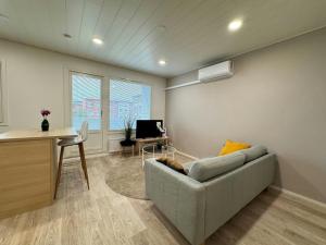 a living room with a couch and a desk at Convenient Apartment for 2 in Kotka