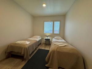 a room with two beds and a window at Convenient Apartment for 2 in Kotka