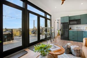 a kitchen with green cabinets and a view of a deck at Alpine Abode - Hot Tub, Nature in Brookville