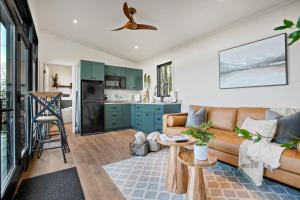 a living room with a couch and a kitchen at Alpine Abode - Hot Tub, Nature in Brookville