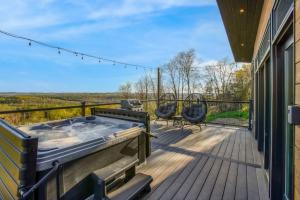 a hot tub on the deck of a house at Alpine Abode - Hot Tub, Nature in Brookville +13 photos