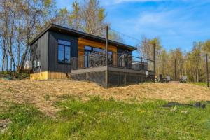 a house on a hill with a balcony at Alpine Abode - Hot Tub, Nature in Brookville