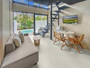 a living room with a couch and a table at Villa Byu By Local Property Team in Balian