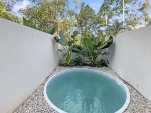 a bath tub in the corner of a garden at Villa Byu By Local Property Team in Balian