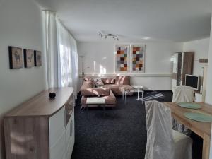 a living room with a couch and a table at Ferienwohnung Waldblick in Heiligenzell