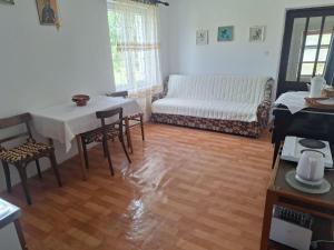 a living room with a table and a couch at Topole 2  +8 photos