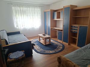 a small room with two beds and a table at Topole 2 