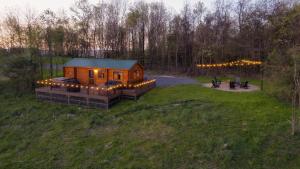 a cabin in the middle of a field with lights at Sanctuary Summit - Hot Tub in Brookville +4 photos