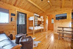 a log cabin with a bunk bed and a desk at Sanctuary Summit - Hot Tub in Brookville