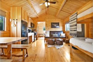 a kitchen and living room in a log cabin at Sanctuary Summit - Hot Tub in Brookville