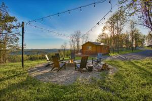 a backyard with a fire pit and a cabin at Sanctuary Summit - Hot Tub in Brookville