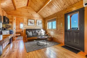 a living room with a couch in a wooden house at Hillside Hideaway - Hot Tub in Brookville