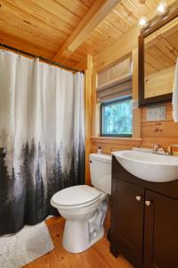 a bathroom with a toilet and a sink at Hillside Hideaway - Hot Tub in Brookville