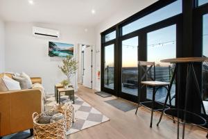 a living room with a view of a balcony at Skyline Serenity - Hot Tub in Brookville