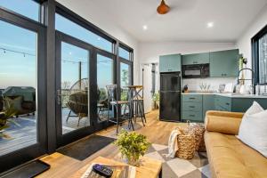 a kitchen and living room with a couch and a table at Skyline Serenity - Hot Tub in Brookville