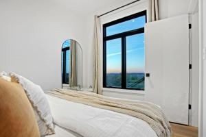 a bedroom with a bed and a large window at Skyline Serenity - Hot Tub in Brookville