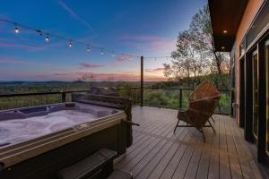 a hot tub on the deck of a house at Skyline Serenity - Hot Tub in Brookville