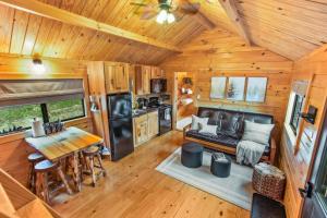 a kitchen and living room of a tiny house at Evergreen Escape - Hot Tub in Shippenville