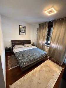 a bedroom with a bed and a window with curtains at Rita Apartment-FREE PARKING&WIFI in Zagreb