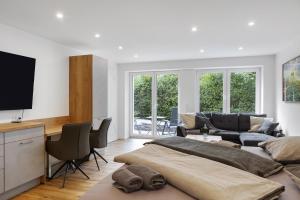 ein Wohnzimmer mit einem Bett und einer Couch in der Unterkunft Ferienwohnung 1 Coburg-Creidlitz in Coburg