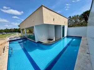 a large blue swimming pool with a building at Casabela - Summer Ville - Lençóis Maranhenses in Barreirinhas