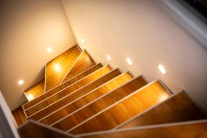 a set of wooden stairs in a building at San Nicola House in Enna