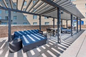 a patio with a couch and a table and a building at Drury Plaza Hotel San Antonio North Stone Oak in San Antonio