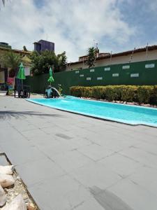 an empty swimming pool in front of a building at Pousada e Hostel F C in Natal +24 photos