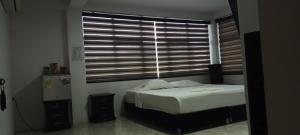 a bedroom with a bed in front of a window at Nuestra Tierra Hotel Boutique in Mocoa