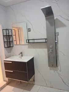 a bathroom with a sink and a mirror at Viva Hôtel Ouaga 2000 in Ouagadougou