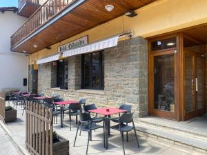 a row of tables and chairs outside of a restaurant at Hostal Collsacabra in L’ Esquirol