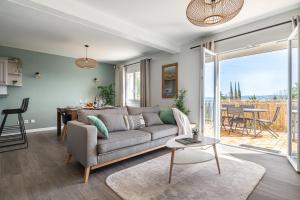 a living room with a couch and a table at Le Cocon des Allamandières in Chonas-lʼAmballan