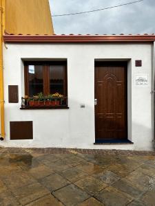 a white building with a door and a window at Casa Ipogeo in SantʼAntìoco +17 photos