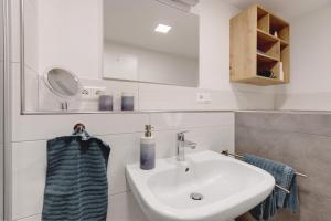 a bathroom with a sink and a mirror at Ferienwohnung Staffe in Bonndorf im Schwarzwald +19 photos