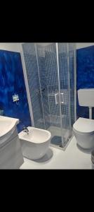 a bathroom with a toilet and a sink and a shower at Lucky House Muravera in Muravera