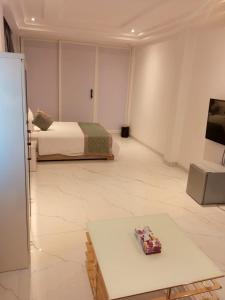 a room with a bed and a table in it at Viva Hôtel Ouaga 2000 in Ouagadougou