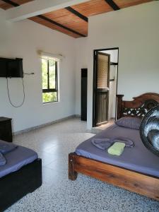 a bedroom with two beds and a television in it at Narv extrema in Utica