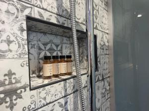 a shelf with five bottles of oils on it at XIX Boutique in Skopje