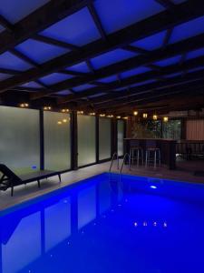 a swimming pool with blue lights in a building at HALAL odmor - Villa Vrbas in Gornji Vakuf