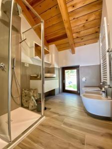 a bathroom with a large tub and a sink at La Mansarda Di Crevari in Crevari