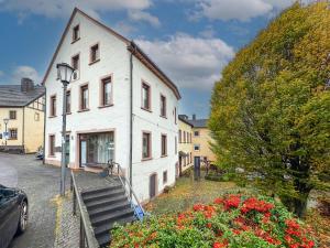 a white building with stairs leading up to it at Eifelleben Hillesheim in Hillesheim