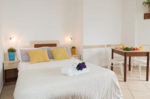 a bedroom with a white bed with flowers on it at Residence Mediterraneo in Rimini