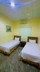 Ένα ή περισσότερα κρεβάτια σε δωμάτιο στο منتجع سيتي لاند فله رقم 1