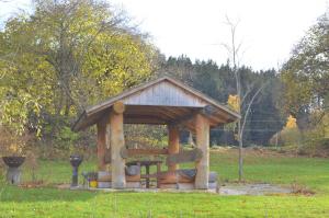 a wooden gazebo in the middle of a field at Ferienwohnung Am Schlössle in Lechbruck