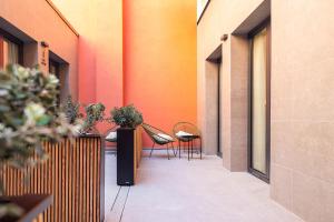 a corridor with two chairs and a table in a building at Brabo Apartments in Hospitalet de Llobregat