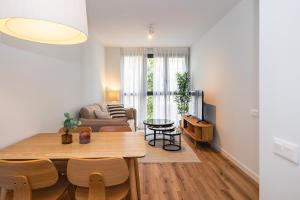 a living room with a table and a couch at Brabo Apartments in Hospitalet de Llobregat