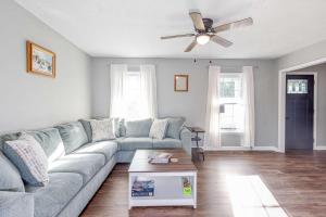 a living room with a couch and a ceiling fan at Blue Sky Landing in Fayetteville
