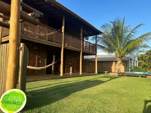a house with a grass yard in front of it at Estação Orgânica Taipu in Marau
