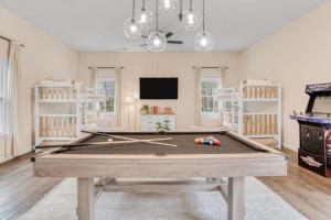 a living room with a pool table and a tv at 5 Bdrm Family Retreat, Pool, HotTub, Golf, Firepit in Greensboro
